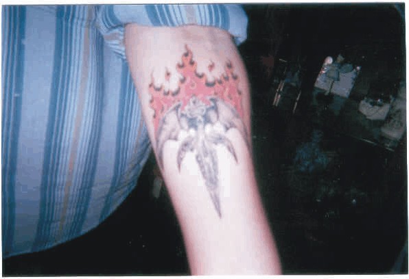 Doug's Flaming Tri-Rÿche tattoo. Artwork done at Skintastic Tattoos & Body 